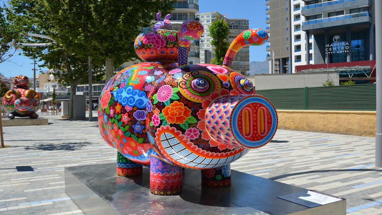 Figure of a coloured pig in a park