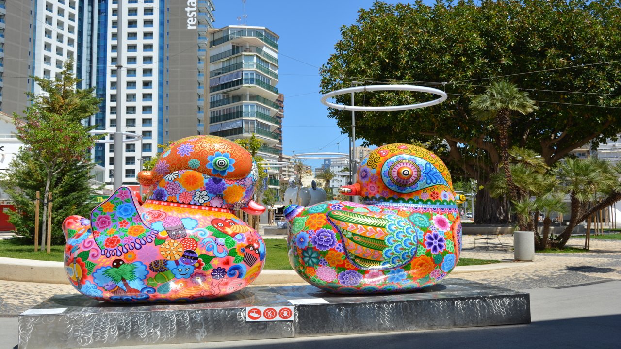 Figures of coloured ducks in a park